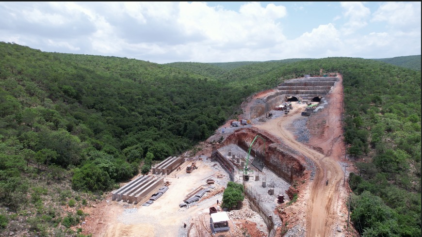 Aerial view of the tunnel approach and casting yard through forested hills