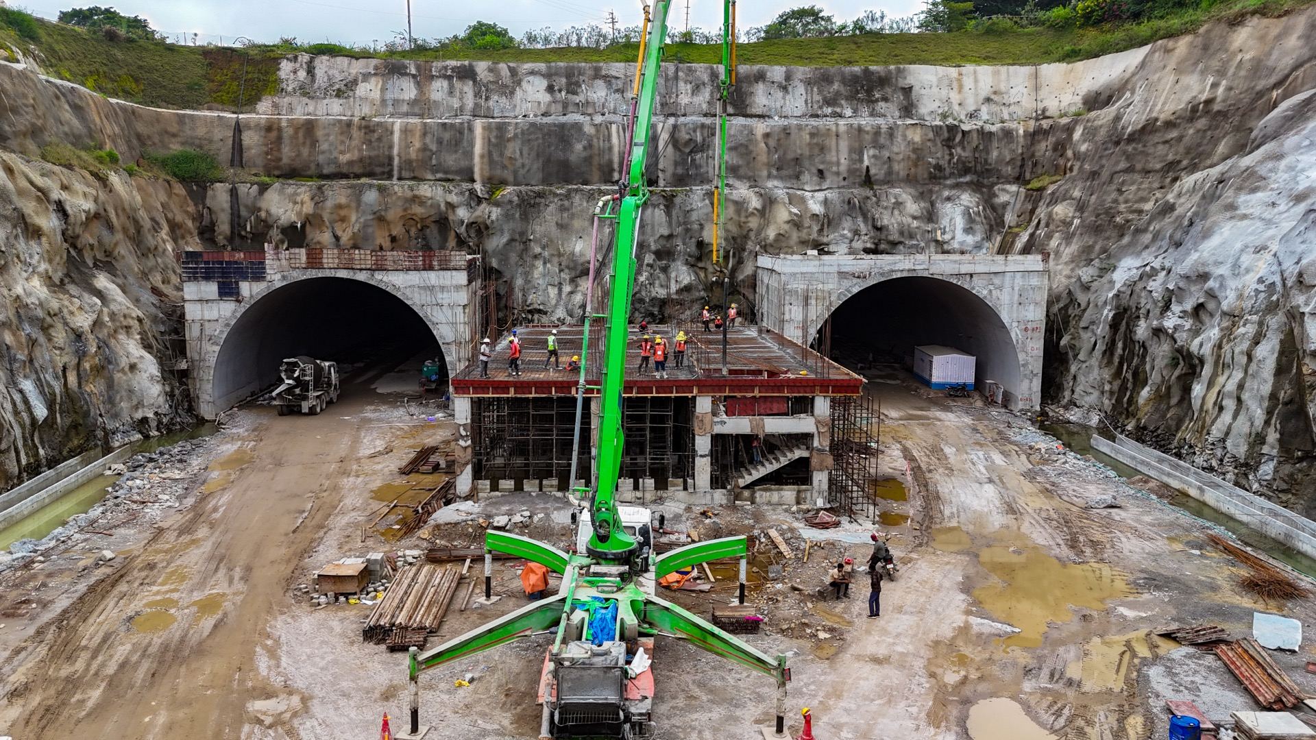Twin tunnel portals with crane at construction site