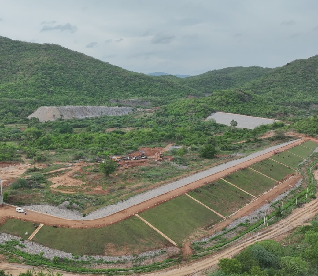 Aerial view of the lined canal approach through green hills, Polavaram
